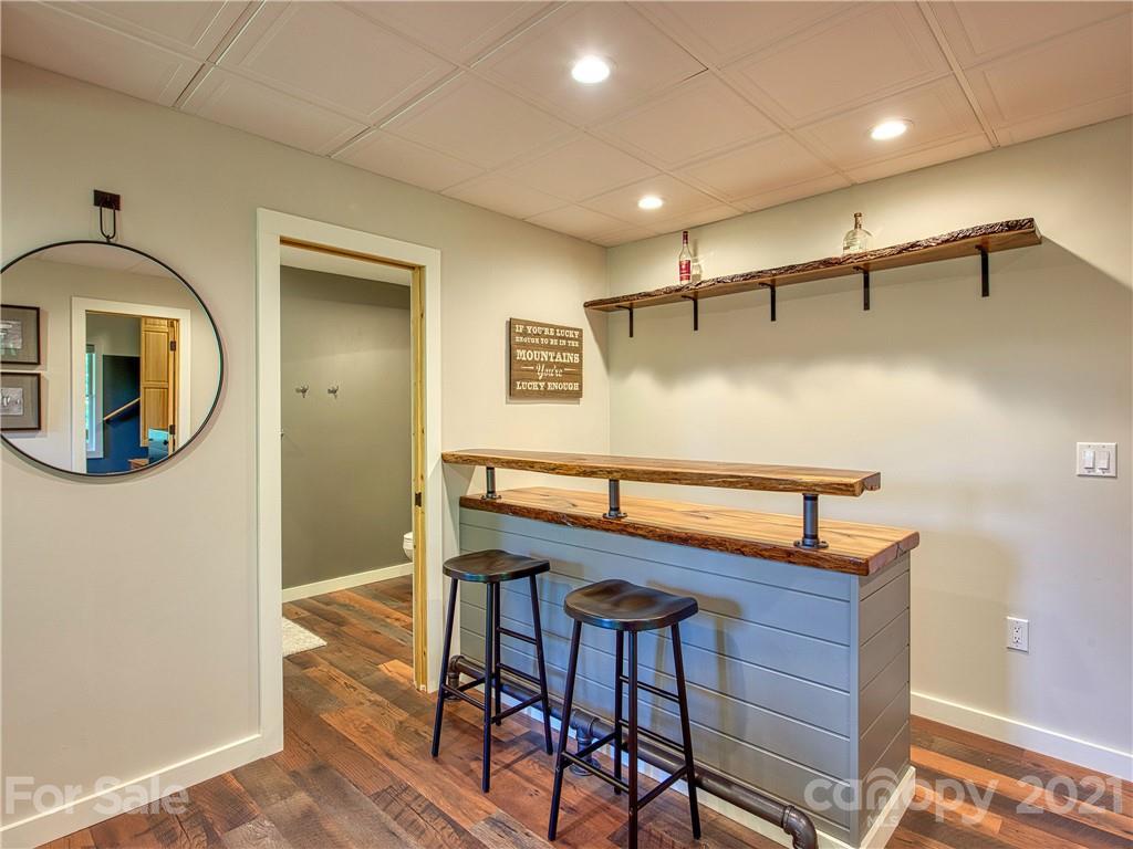 1933 Laurel Ridge North Maggie Valley, NC 28751 - Photo 34 of 44 a bedroom with a bed and a mirror