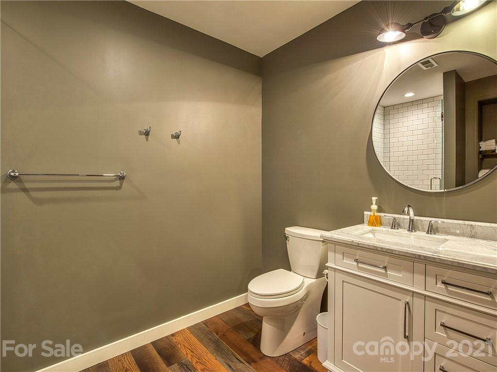 1933 Laurel Ridge North Maggie Valley, NC 28751 - Photo 35 of 44 a bathroom with a toilet sink vanity and mirror
