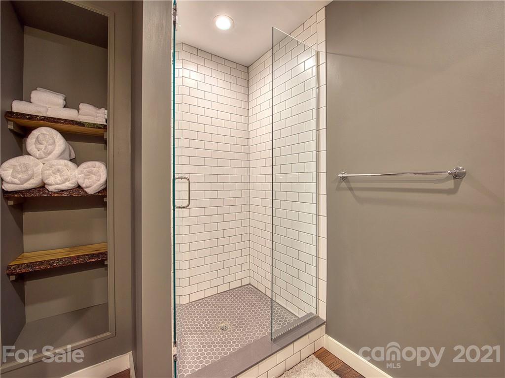 1933 Laurel Ridge North Maggie Valley, NC 28751 - Photo 36 of 44 a bathroom with a glass shower door