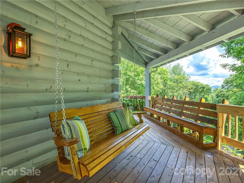 1933 Laurel Ridge North Maggie Valley, NC 28751 - Photo 5 of 44 a balcony with wooden floor and outdoor seating