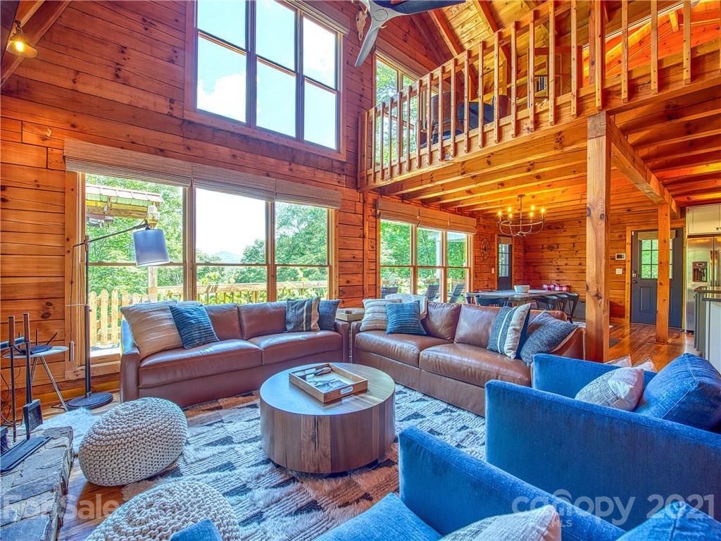 1933 Laurel Ridge North Maggie Valley, NC 28751 - Photo 8 of 44 a living room with furniture a fireplace and a large window