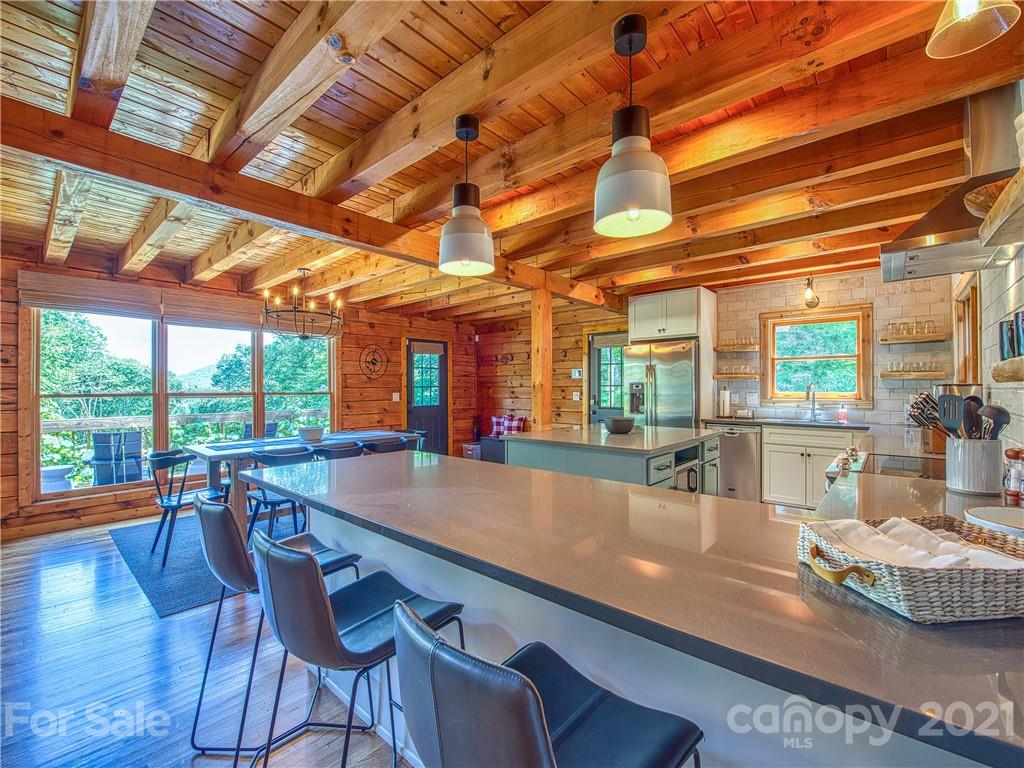 1933 Laurel Ridge North Maggie Valley, NC 28751 - Photo 10 of 44 a dining room with furniture a chandelier and wooden floor