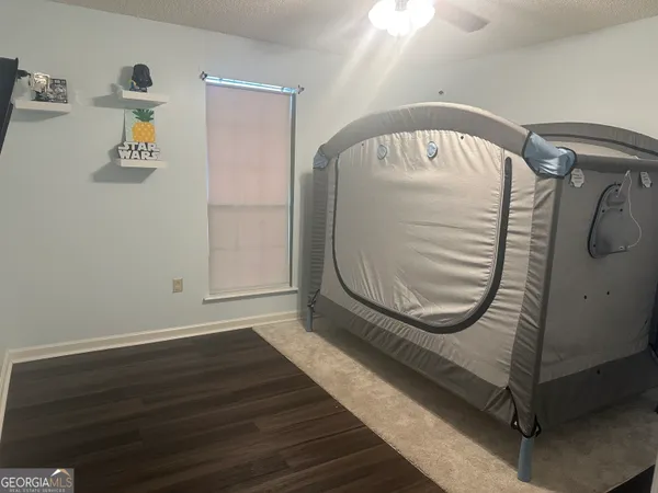 a room with a wooden floor and white walls