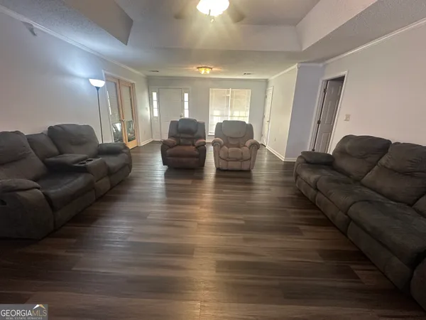 a living room with furniture and wooden floor