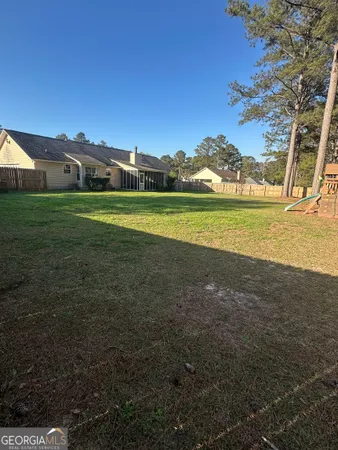 a view of a big house with a big yard