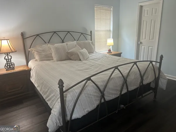 a bedroom with a bed and a lamp