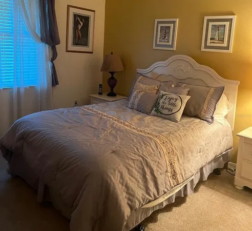 a bedroom with a bed and wall painting