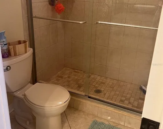 a bathroom with a toilet and shower
