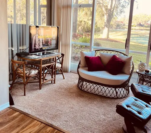 a living room with furniture and a floor to ceiling window