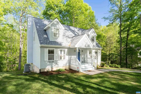 a front view of house with yard and green space