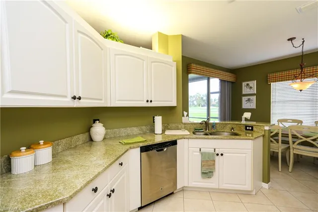 a kitchen with a sink a stove and cabinets
