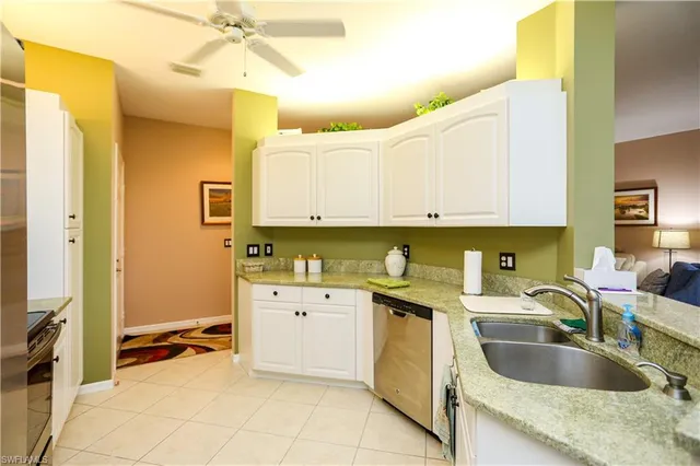 a kitchen with a sink a stove and cabinets