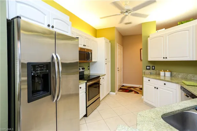 a kitchen with stainless steel appliances a stove refrigerator and cabinets