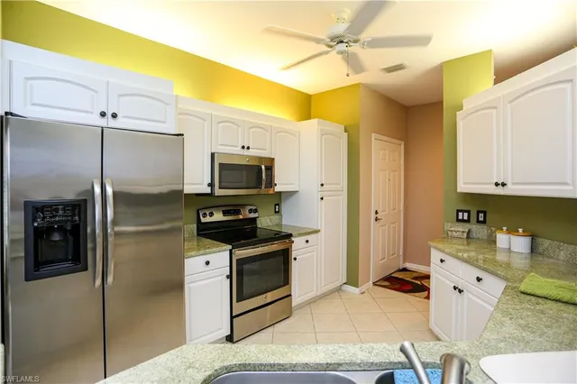 a kitchen with stainless steel appliances a stove a refrigerator and cabinets