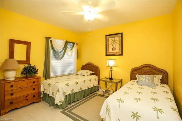 a bedroom with two beds and painting on the wall