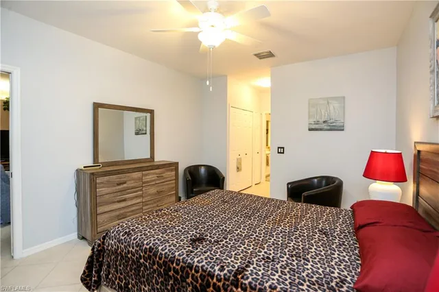 a bedroom with a bed and a lamp