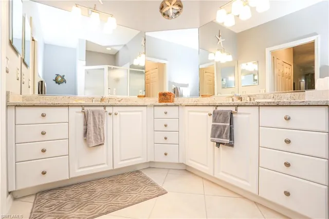 a large white kitchen with granite countertop a sink