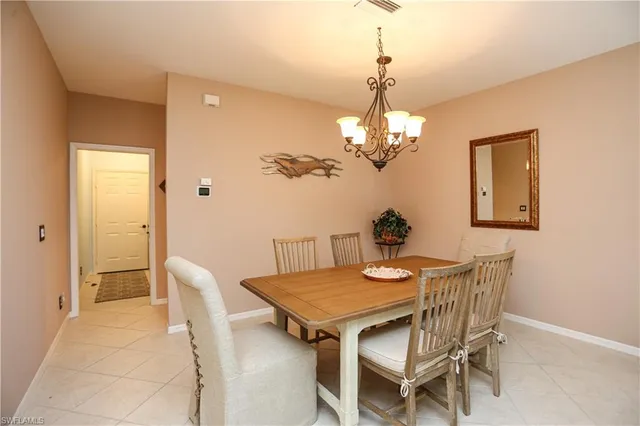 a view of a dining room with furniture and chandelier