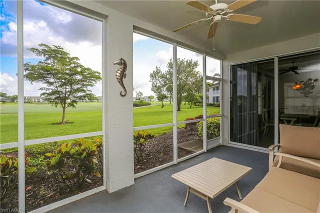a view of a porch with furniture and yard