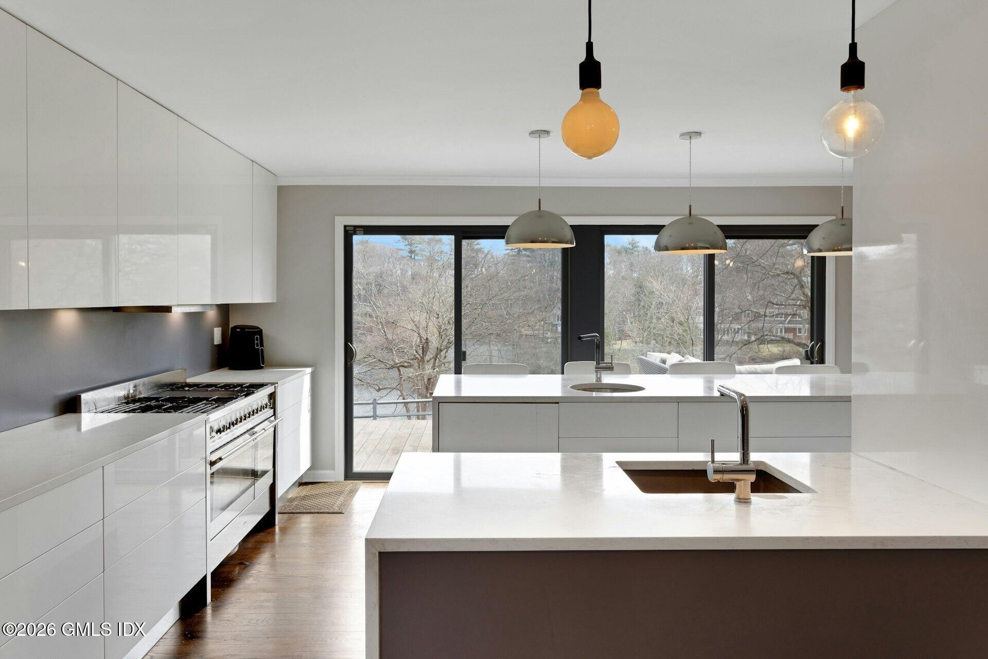 83 Burning Tree Road Greenwich, CT 06830 - Photo 11 of 26 a kitchen with a sink and a stove