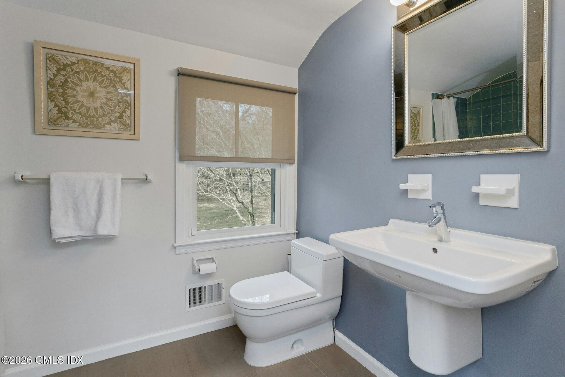 83 Burning Tree Road Greenwich, CT 06830 - Photo 18 of 26 a bathroom with a toilet a sink and mirror