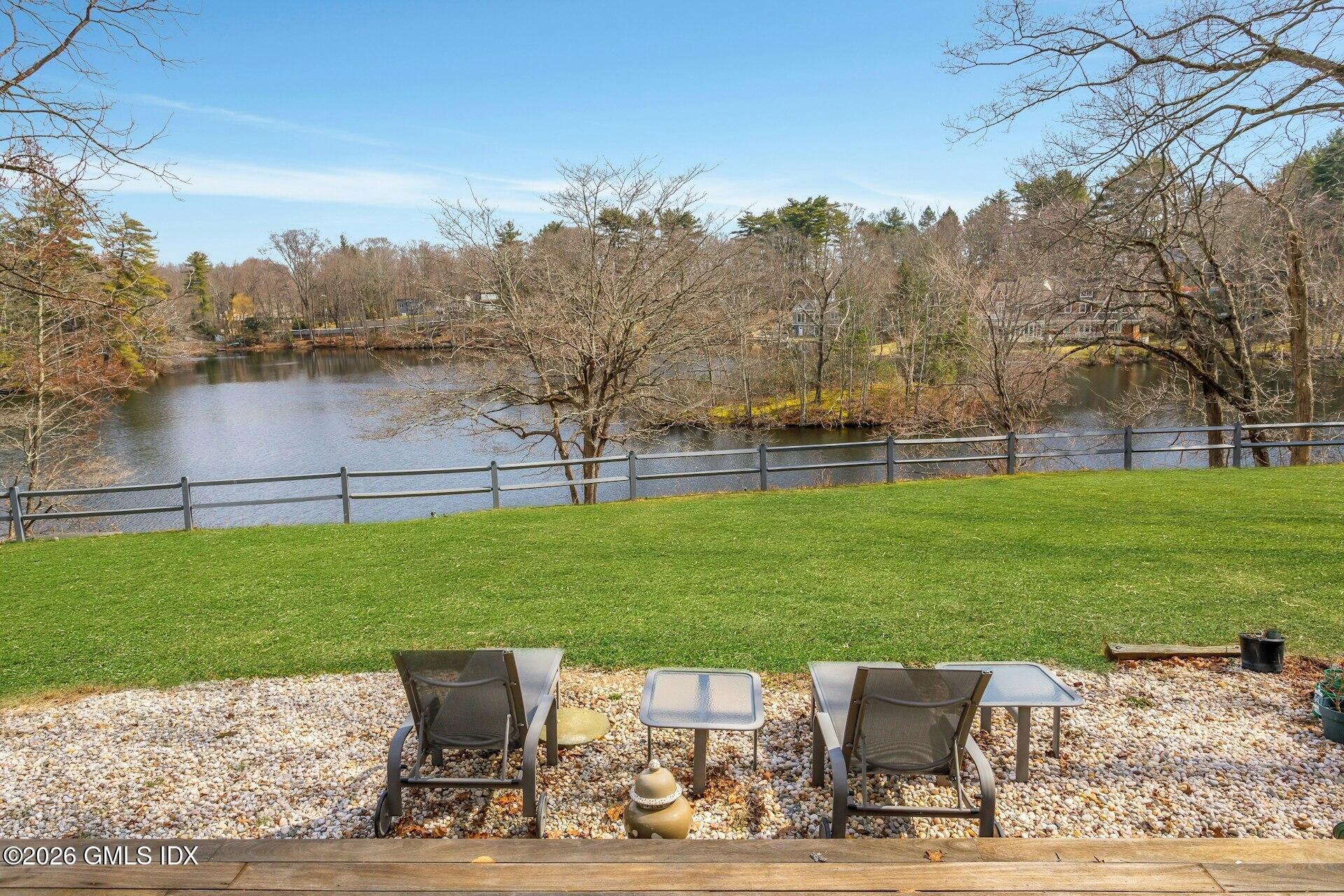 83 Burning Tree Road Greenwich, CT 06830 - Photo 20 of 26 a view of a garden with a bench in the patio
