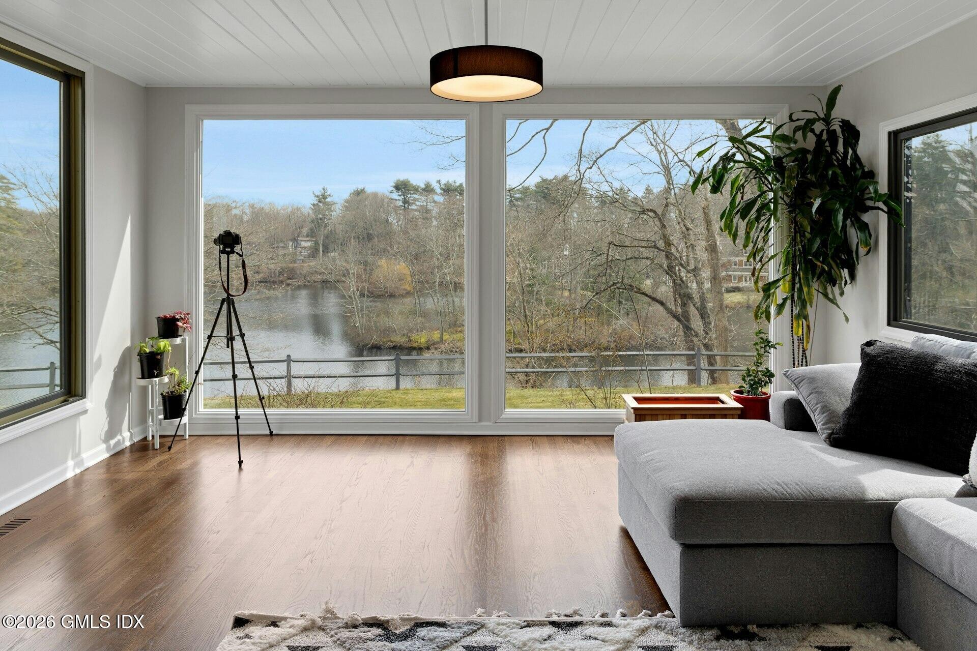 83 Burning Tree Road Greenwich, CT 06830 - Photo 4 of 26 a living room with couch and a large window