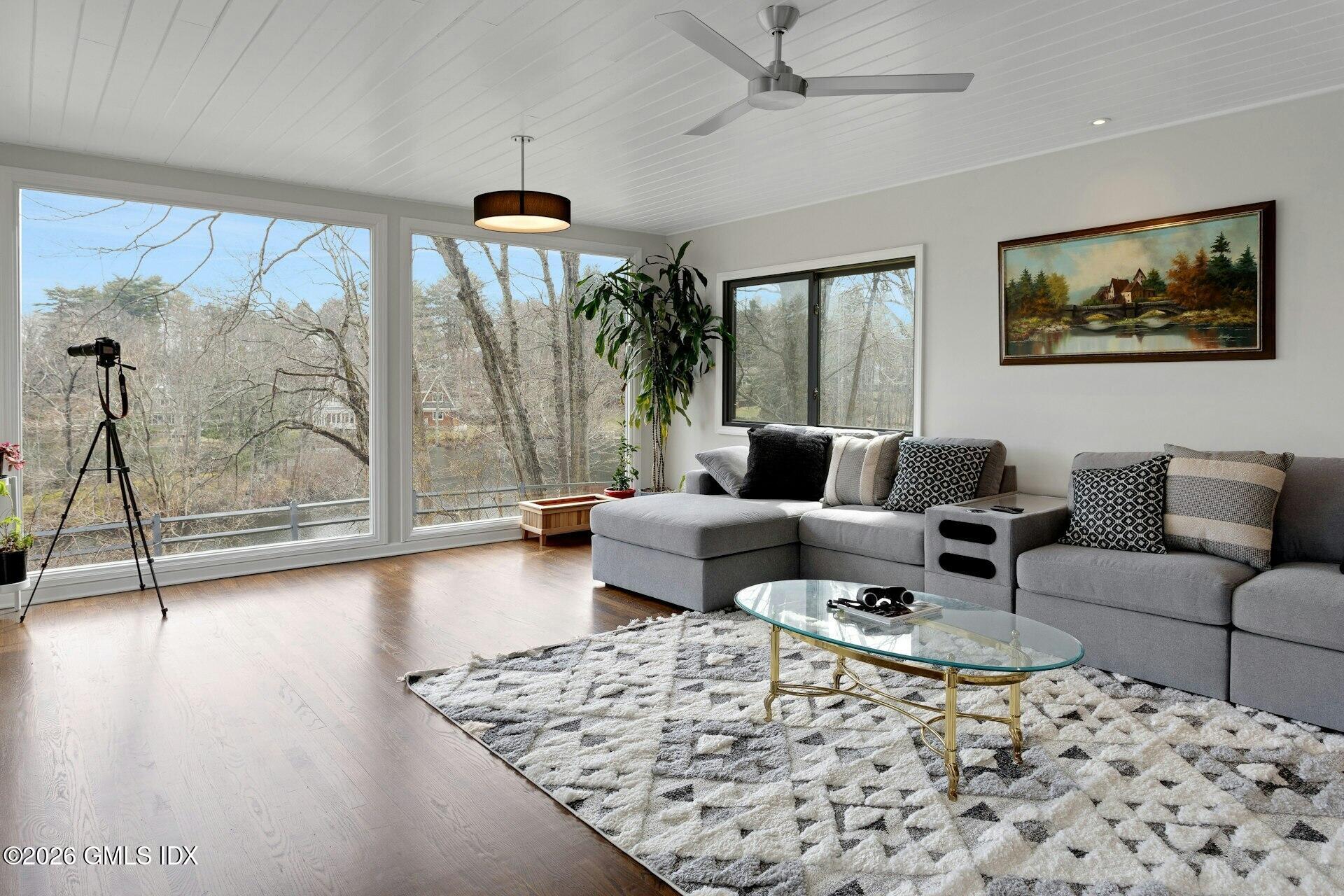 83 Burning Tree Road Greenwich, CT 06830 - Photo 5 of 26 a living room with furniture and a large window