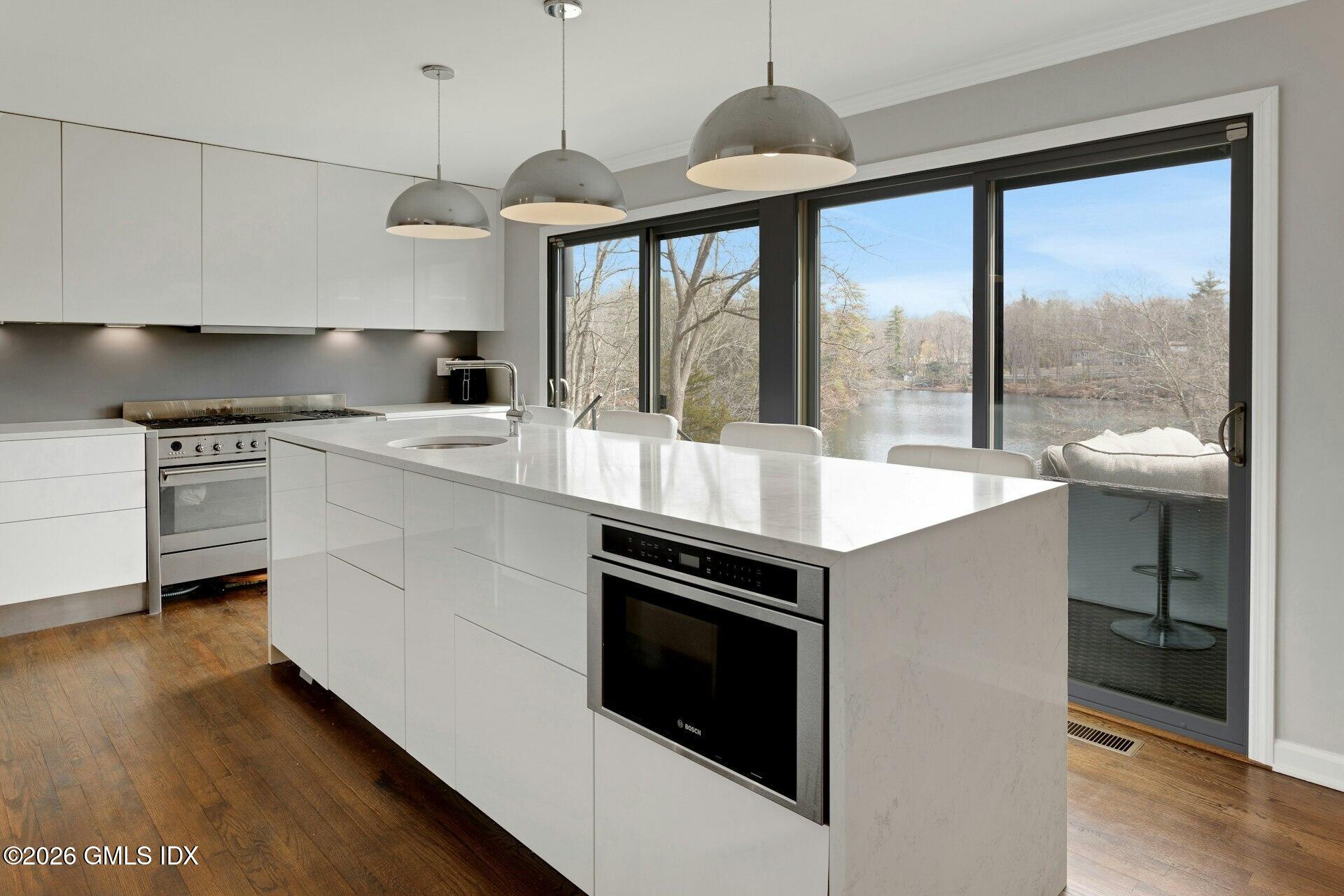 83 Burning Tree Road Greenwich, CT 06830 - Photo 9 of 26 a open kitchen with stainless steel appliances granite countertop a stove a sink and a refrigerator