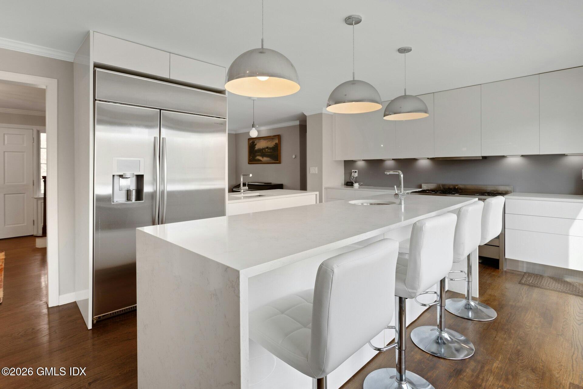 83 Burning Tree Road Greenwich, CT 06830 - Photo 10 of 26 a large kitchen with stainless steel appliances a large counter top a stove and a refrigerator