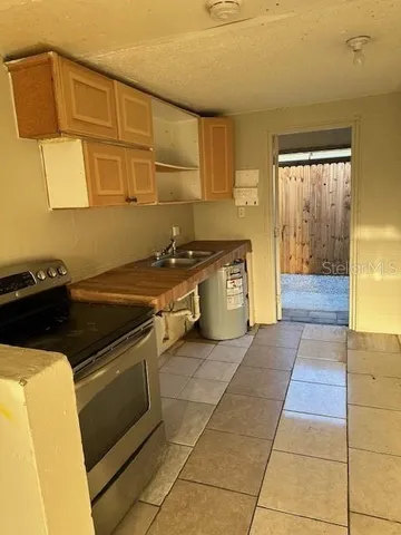 a kitchen with a stove top oven cabinets and a counter top space