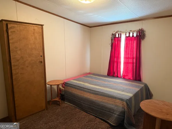 a bed room with a bed and window