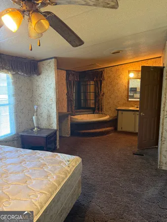 a view of a livingroom with furniture and a window