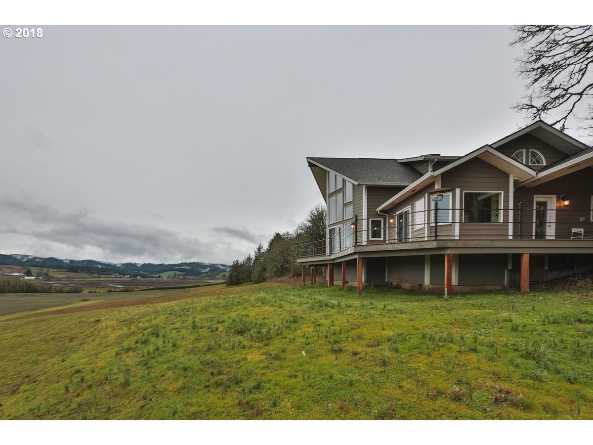 13205 Southwest Spring Hill Road Gaston, OR 97119 - Photo 27 of 30 a view of a house with a big yard and large trees