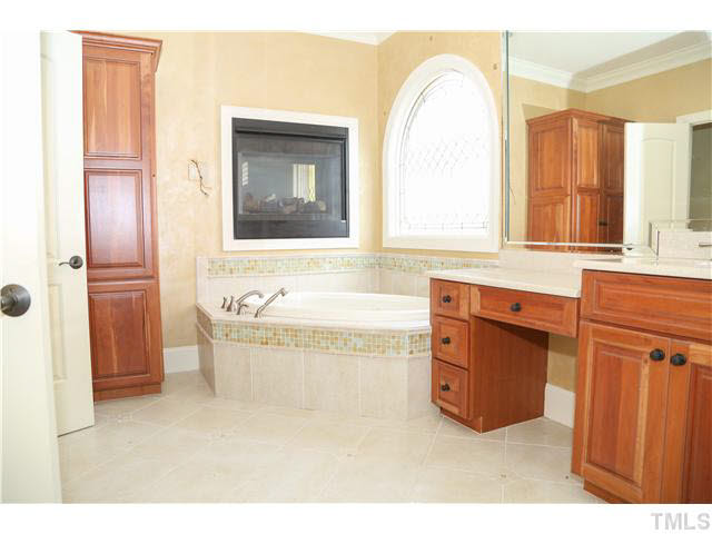 1816 Torrington Street Raleigh, NC 27615 - Photo 13 of 25 a spacious bathroom with a tub a mirror and a sink