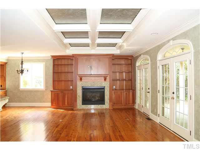 1816 Torrington Street Raleigh, NC 27615 - Photo 8 of 25 a view of empty room with a fireplace and wooden floor
