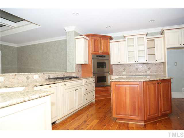 1816 Torrington Street Raleigh, NC 27615 - Photo 10 of 25 a kitchen with stainless steel appliances granite countertop a stove a sink and a refrigerator