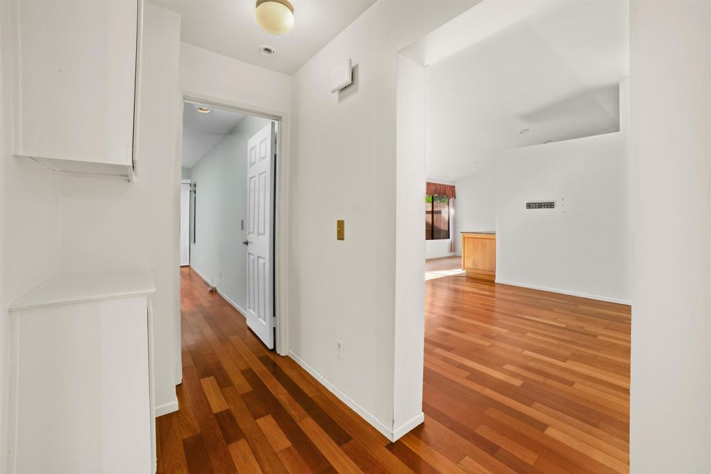 1387 Longfellow Road Vista, CA 92081 - Photo 19 of 38 a view of a hallway with wooden floor and staircase