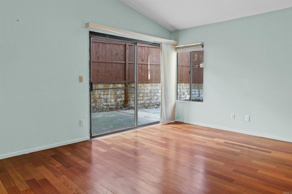 1387 Longfellow Road Vista, CA 92081 - Photo 22 of 38 a view of an empty room with wooden floor and a window