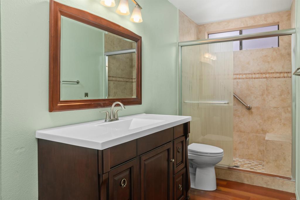 1387 Longfellow Road Vista, CA 92081 - Photo 23 of 38 a bathroom with a sink vanity mirror and toilet
