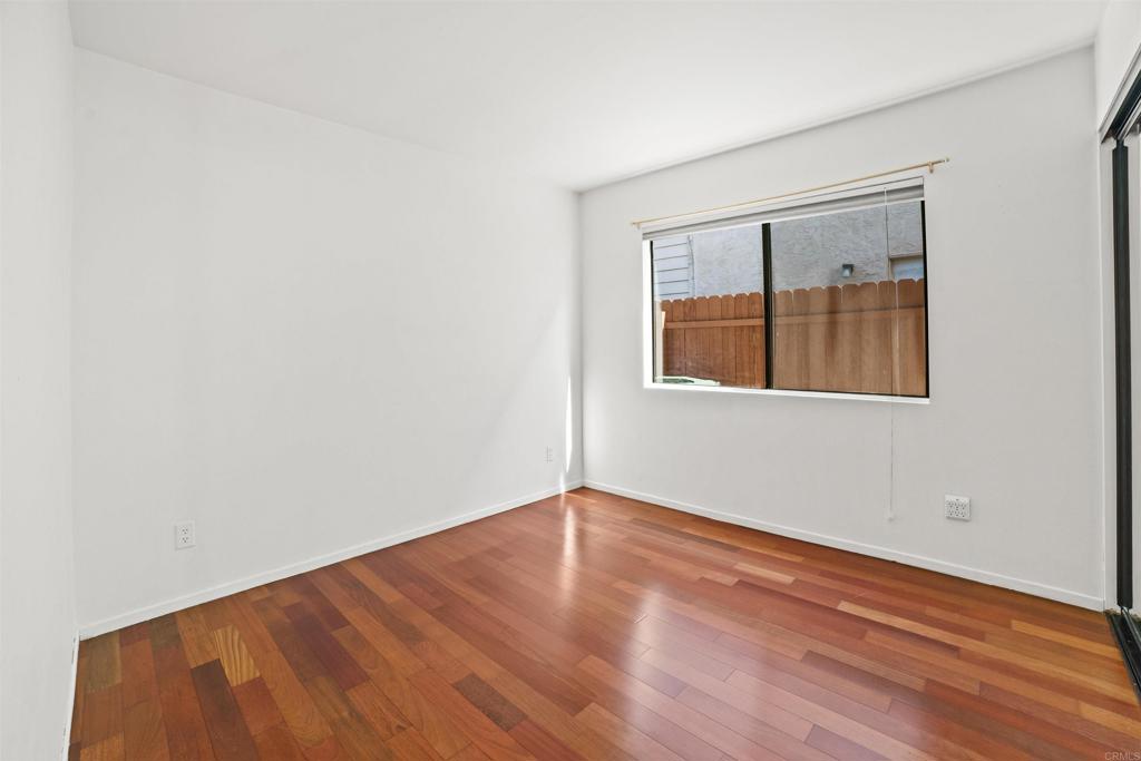 1387 Longfellow Road Vista, CA 92081 - Photo 26 of 38 an empty room with wooden floor and windows