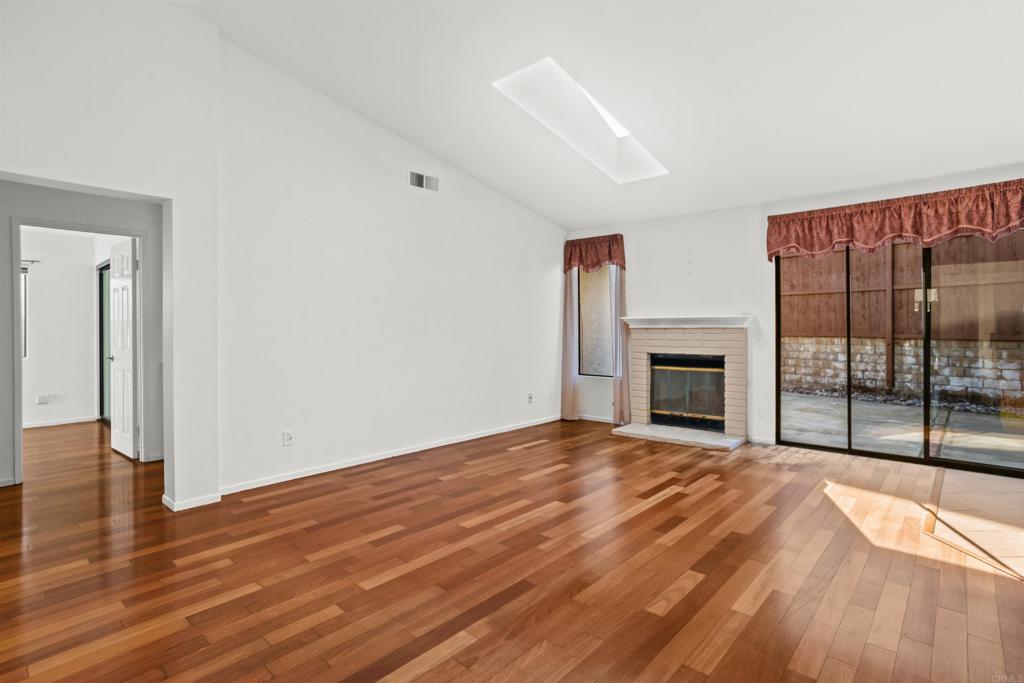 1387 Longfellow Road Vista, CA 92081 - Photo 6 of 38 a view of empty room with wooden floor and fireplace
