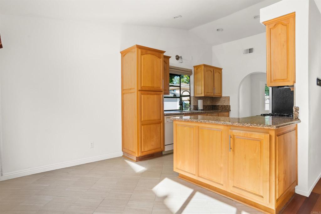 1387 Longfellow Road Vista, CA 92081 - Photo 9 of 38 a kitchen with stainless steel appliances a refrigerator and a stove
