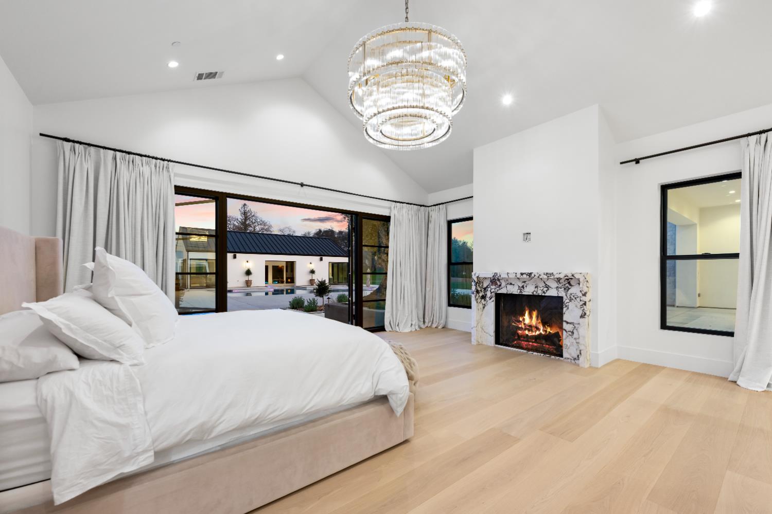 2735 Rattlesnake Road Newcastle, CA 95658 - Photo 59 of 84 a bedroom with a large bed and a fireplace