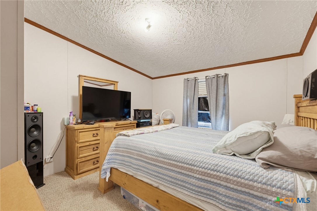 164 County Road 4450 Kempner, TX 76539 - Photo 23 of 44 a bedroom with a bed and a flat screen tv