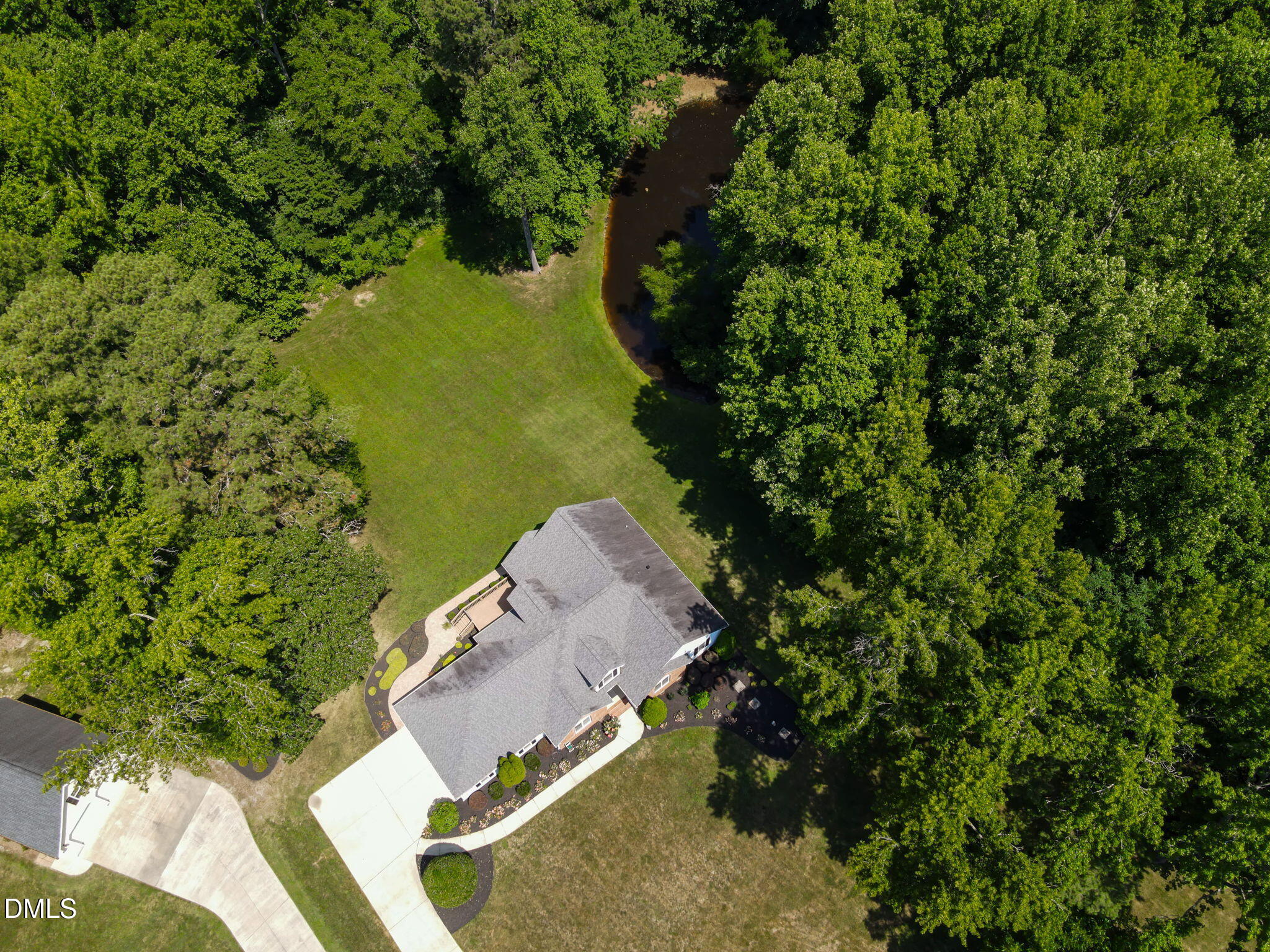 1112 Tyler Farms Drive Raleigh, NC 27603 - Photo 66 of 78 an aerial view of a house with a yard lake and trees all around