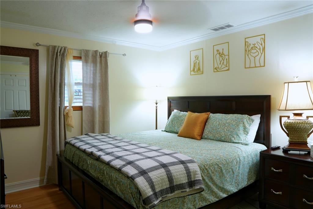 931 20th Street Southeast Naples, FL 34117 - Photo 16 of 21 a bedroom with a bed and wooden floor