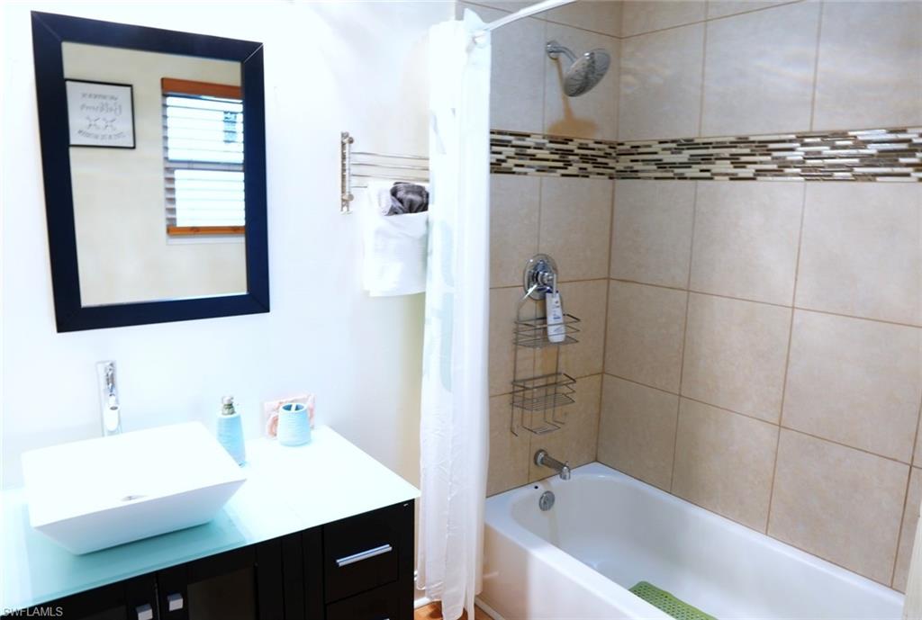 931 20th Street Southeast Naples, FL 34117 - Photo 17 of 21 a bathroom with a tub sink and mirror