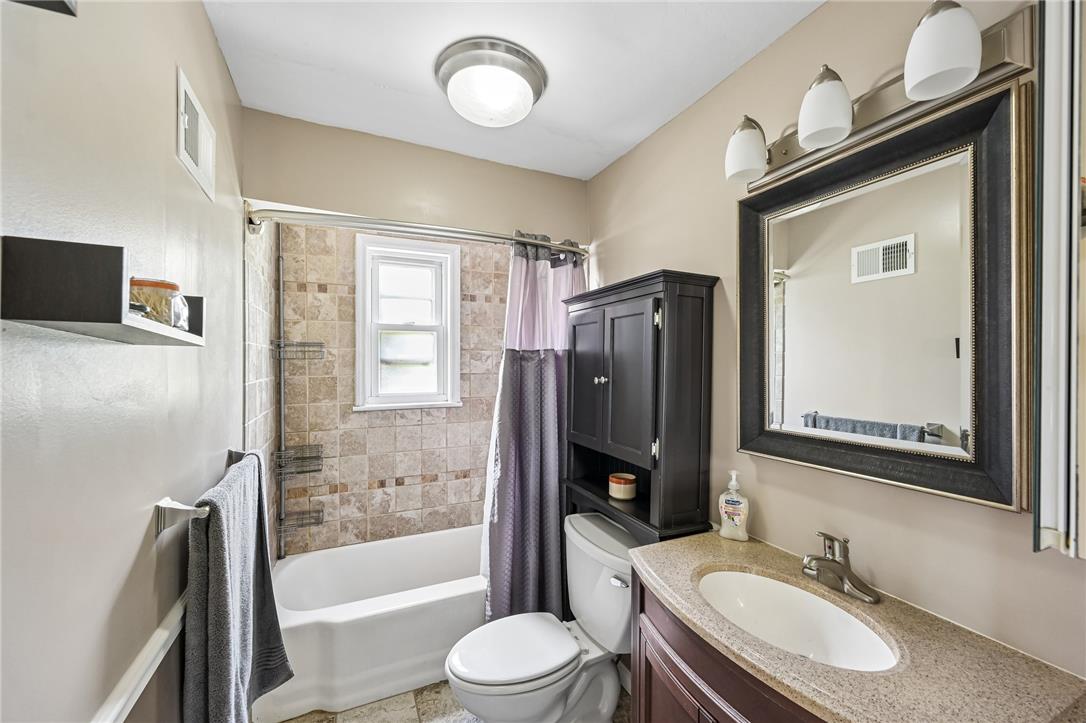 4065 Airport Road Allentown, PA 18109 - Photo 12 of 28 A compact bathing space features a clean tub, tile surround, and an integrated vanity for daily routines.