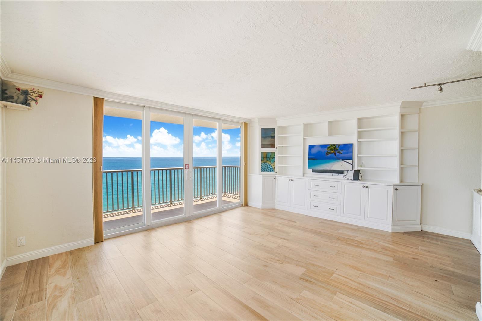400 North Surf Road, Unit 801 Hollywood, FL 33019 - Photo 2 of 17 a view of an empty room with a window and wooden floor
